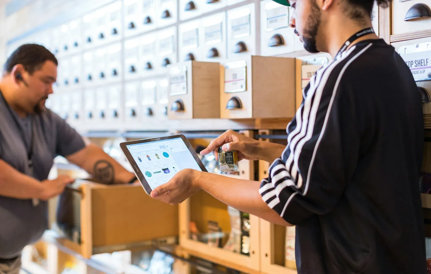 Two people in a store looking at a tablet together