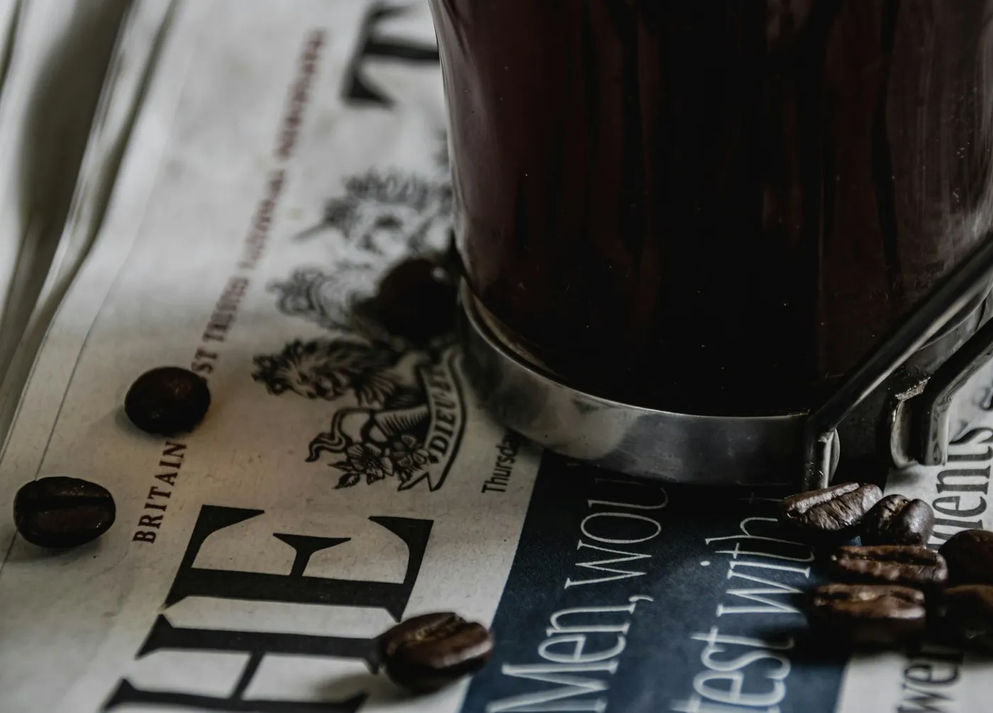 A cup of coffee resting on a newspaper