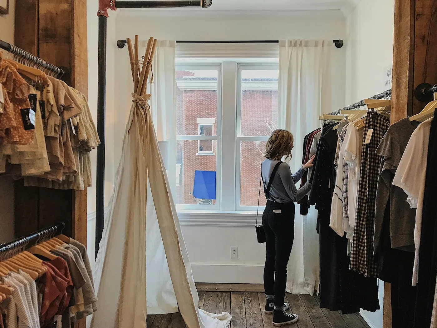A woman selecting clothes from a rail