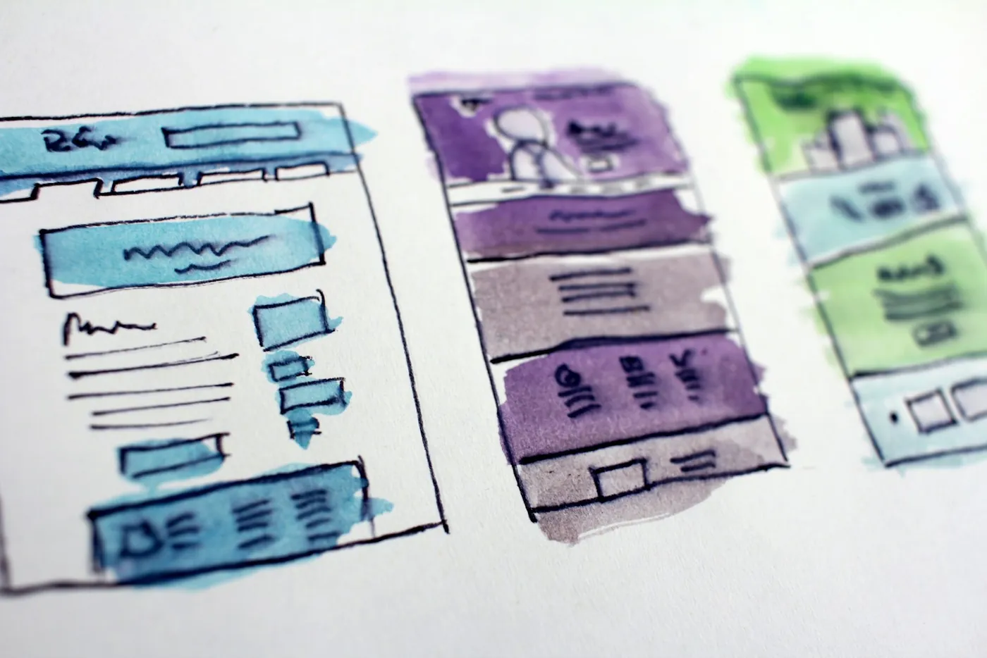 Watercolour wireframe sketches of website layouts