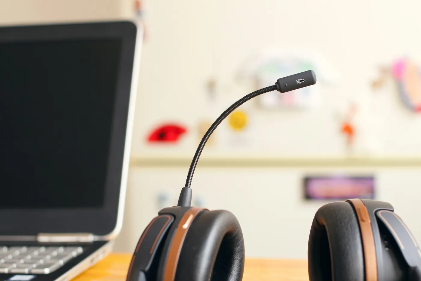 A headset resting beside a laptop computer