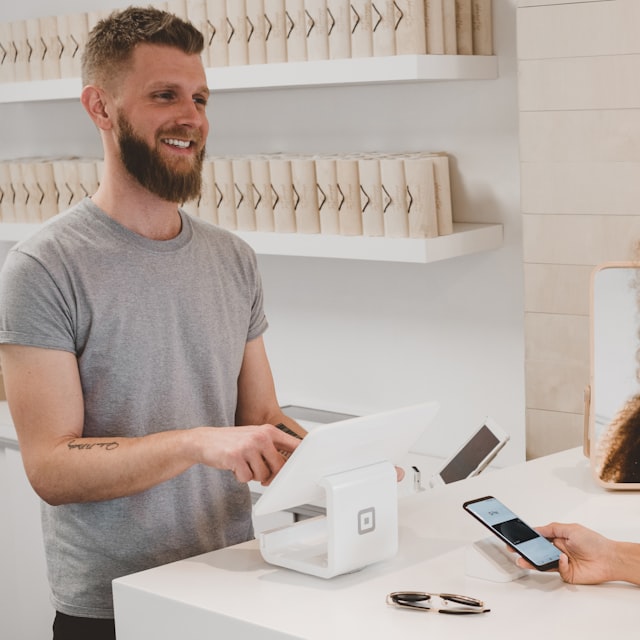Store owner helping a customer at the counter