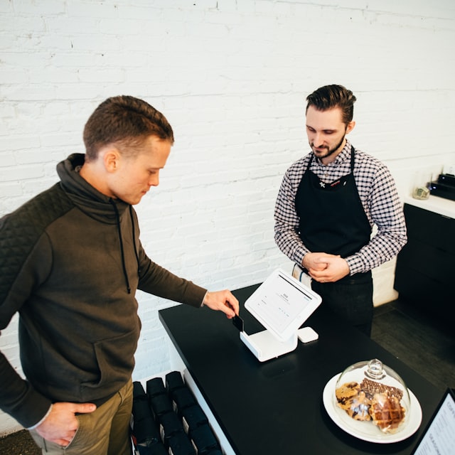 Customer checking out at a cafe counter