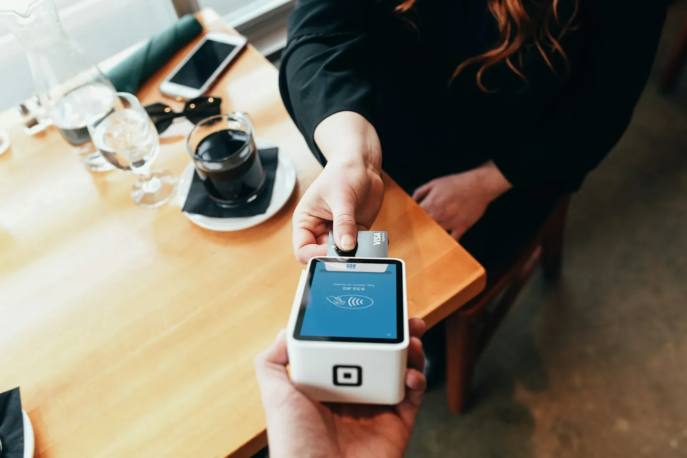 A person holding a card payment machine